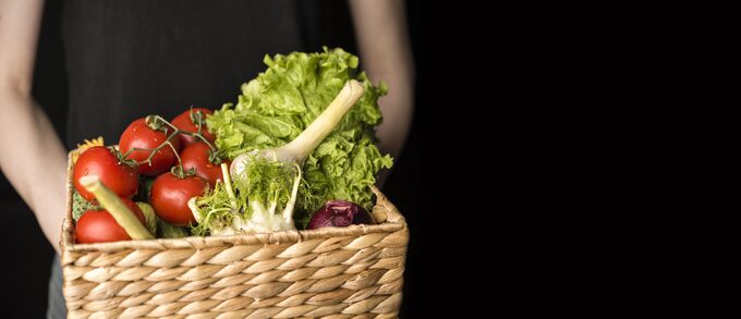 front-view-person-holding-basket-with-veggies.jpg